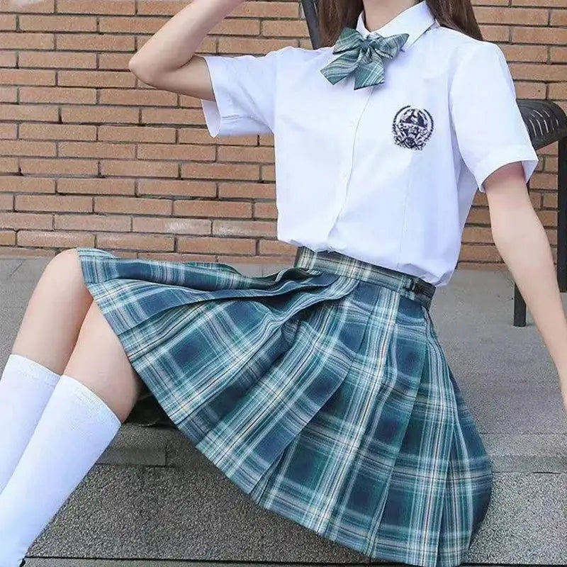 2-piece outfit: ZOKI plaid pleated skirt with bow knot; teal plaid, high-waist, paired with white shirt.