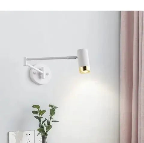 Wall-mounted reading lamp by Simples Market with white telescopic foldable arm and cylindrical shade