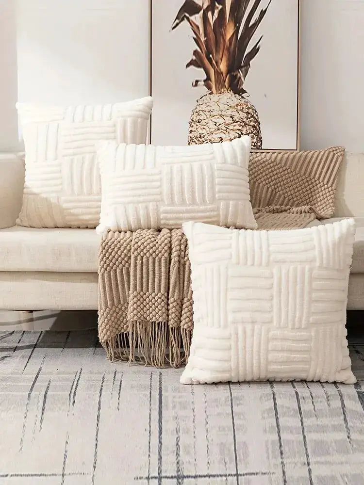 Throw pillow covers in cream white faux fur with a plush boho texture, shown with cushions and a beige blanket on a sofa