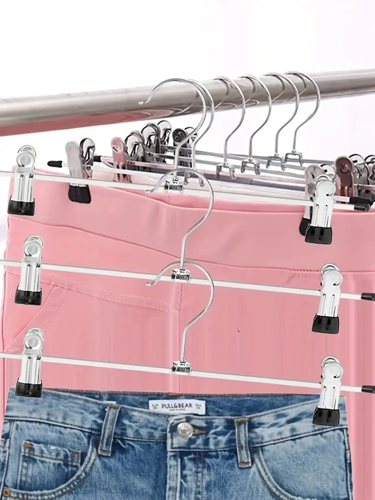 Metal pant rack clip hanger set with black anti-slip clips for drying clothing on a wardrobe rod