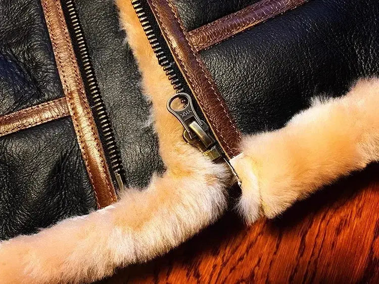 Black leather shearling jacket with beige fur trim and YKK zipper.