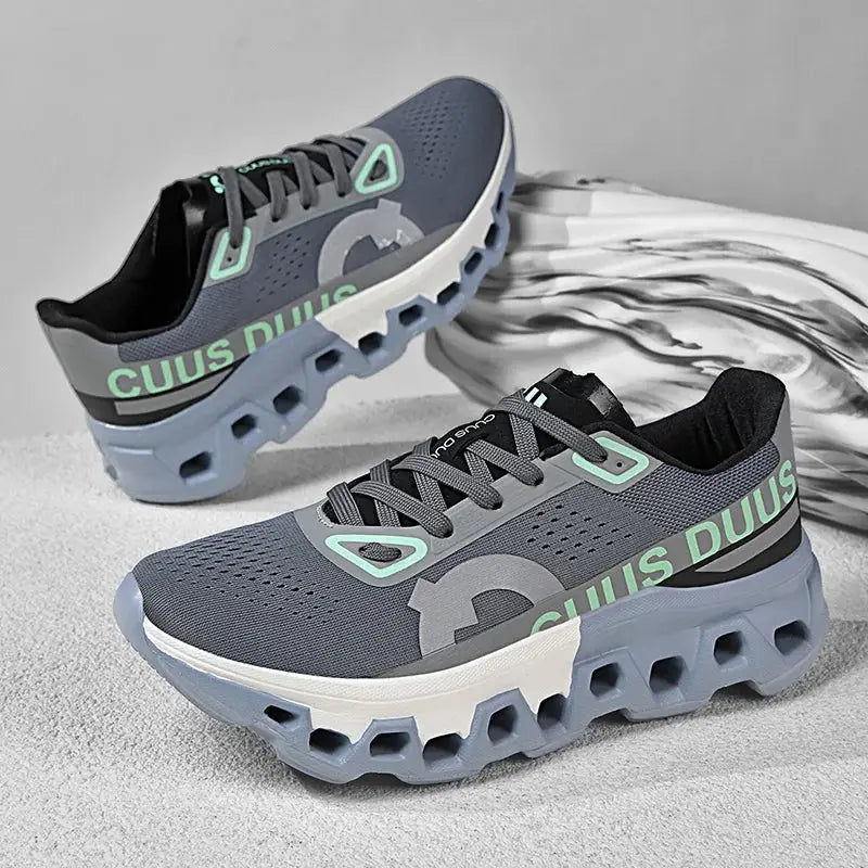 Men's running shoes in grey-blue mesh with mint accents and a chunky cushioned sole; pair by Simples Market