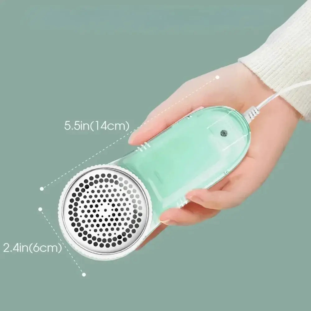 Electric lint remover for clothes; mint-green handheld device with circular perforated metal roller head.