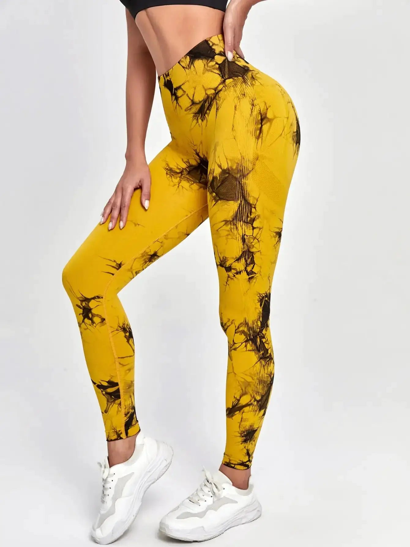 Women's tie-dye high-waist leggings in mustard yellow with black splash pattern, stretchy yoga pants by Simples Market