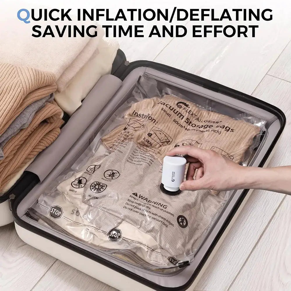 FLEXTAIL portable air pump with light, USB-C charging, used on vacuum storage bag inside a suitcase