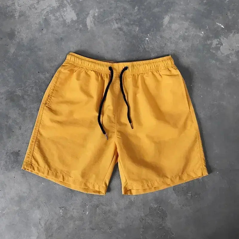 Men's swim shorts mustard yellow with black drawstring, board shorts style