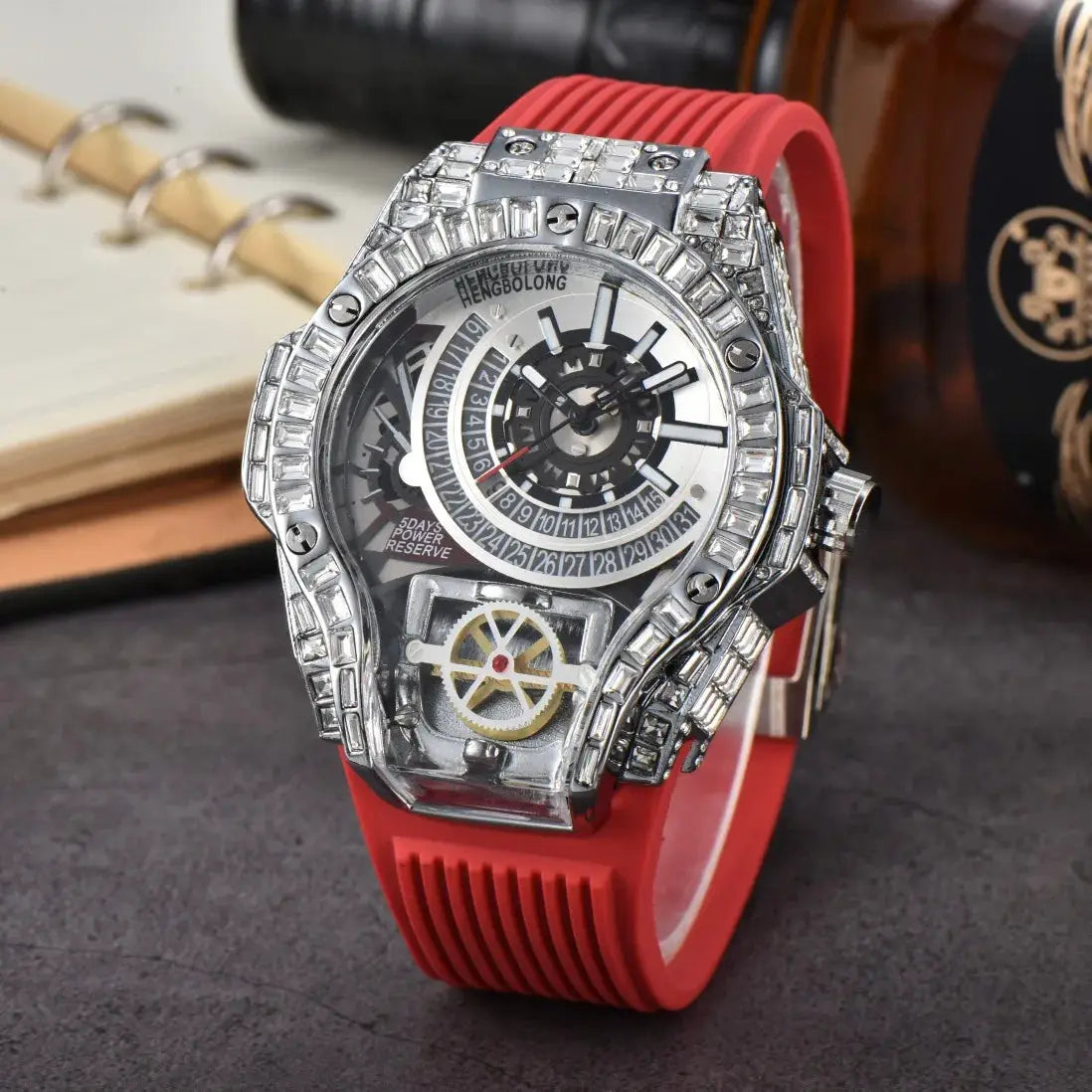 Men's luxury diamond watch with red silicone strap and jeweled skeleton dial