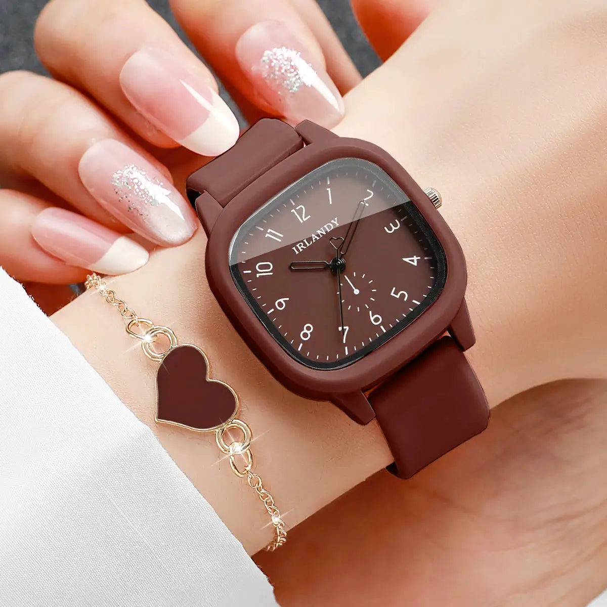 Two-piece watch and heart bracelet set: IRLANDY brown square silicone watch with white numerals; gold heart bracelet.