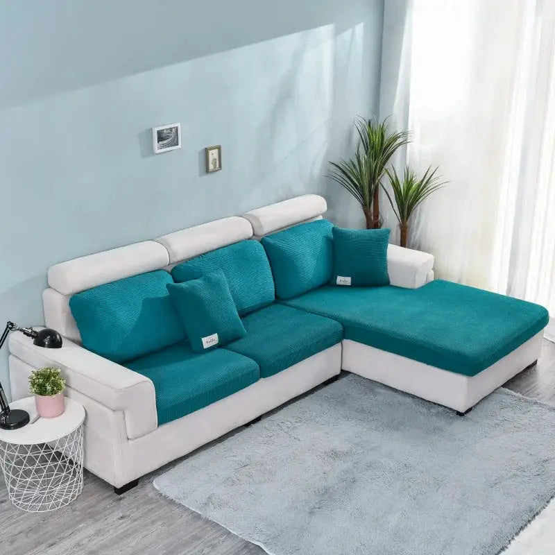 Polar fleece sofa seat cushion covers in teal on a white L-shaped sectional sofa.