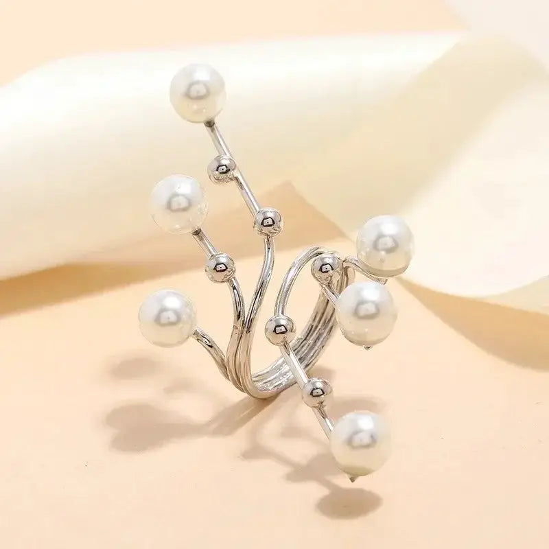 Silver metal ring with irregular branch design and white pearl beads; adjustable fit