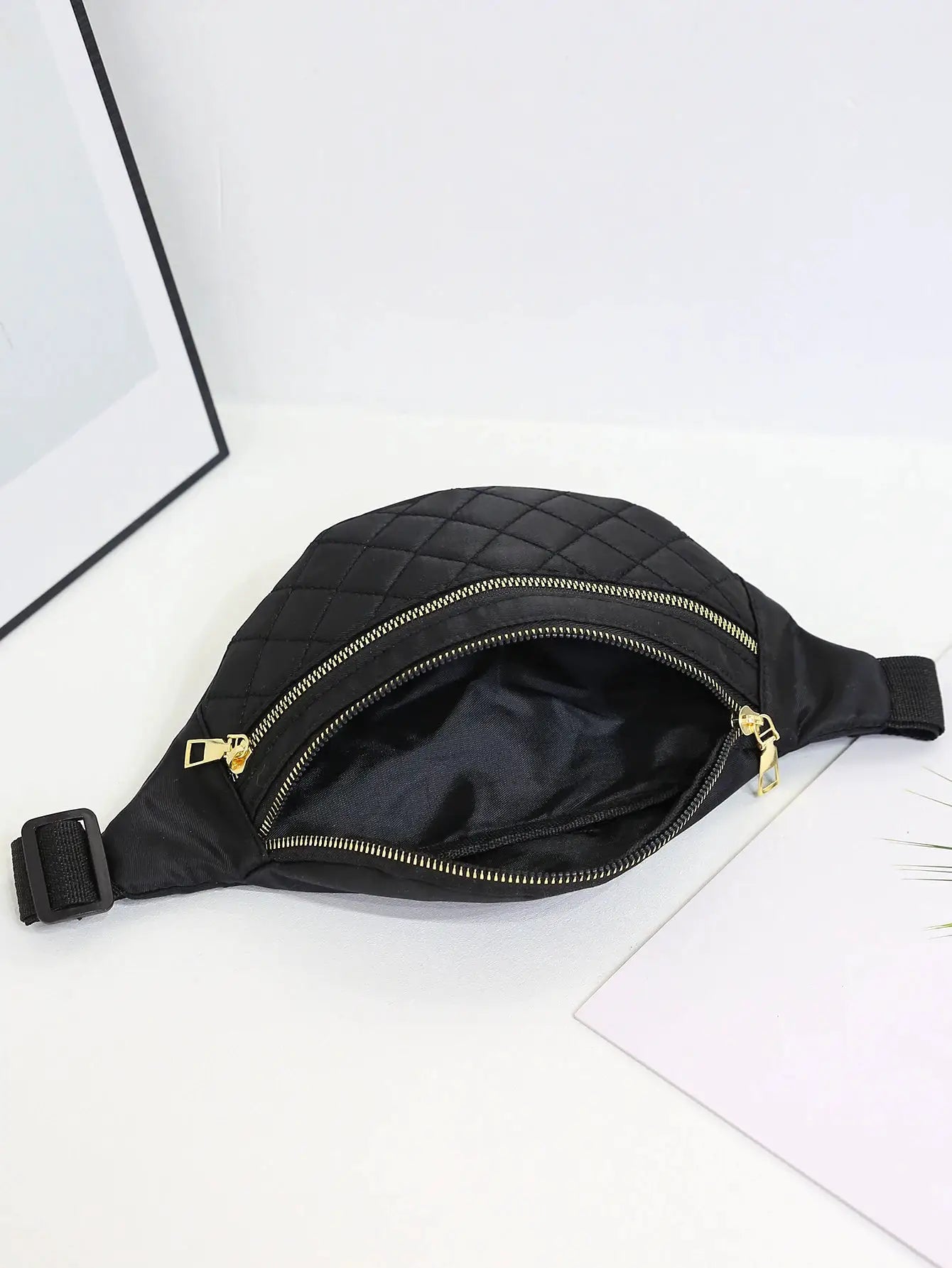 Waist bag for women, black quilted with gold zippers and adjustable strap