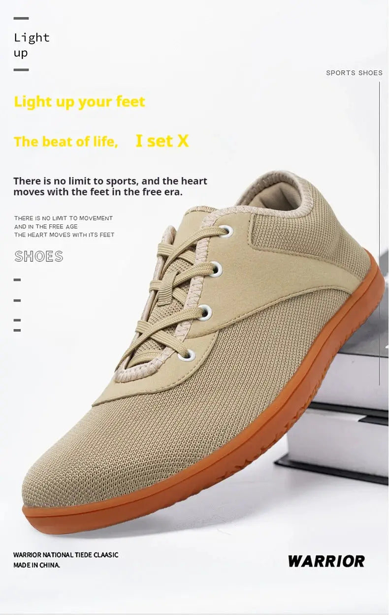 Trail running shoe by Warrior; beige mesh upper, orange sole.