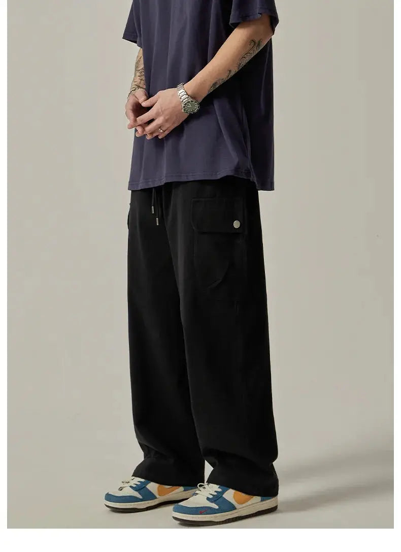 Simples Market men's cargo pants, black wide-leg drawstring trousers with large side pocket flap.