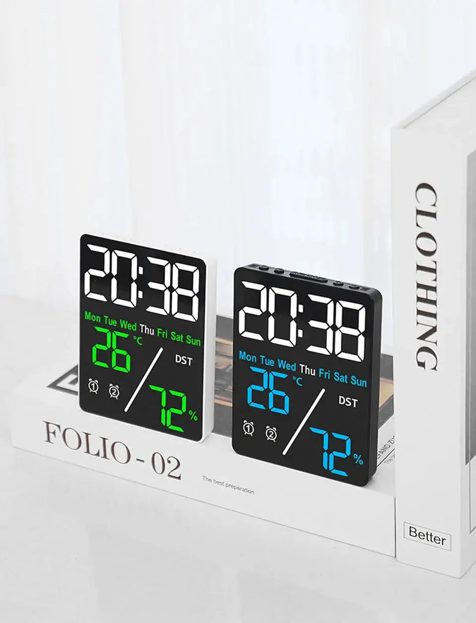 Multifunctional alarm clocks by Simples Market; two black desk clocks display humidity, with green and blue digits.