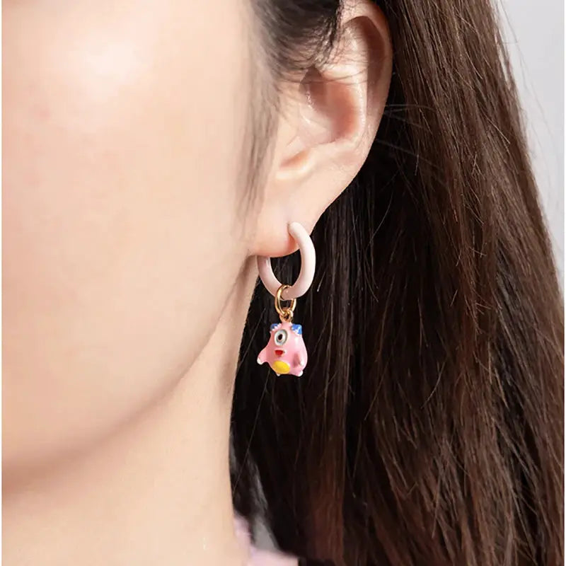 Pink dinosaur pendant single hoop earring with cartoon animal charm.