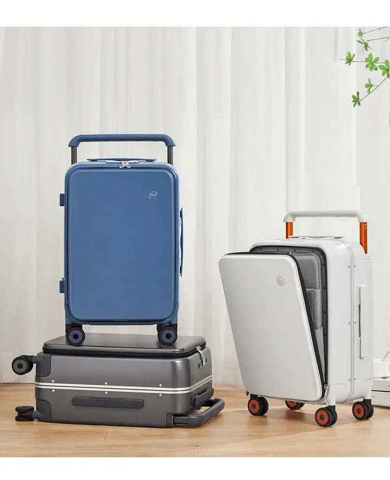 Three-piece Mixi luggage set by Simples Market; blue 20-inch cabin suitcase atop a gray base case and a white carry-on.