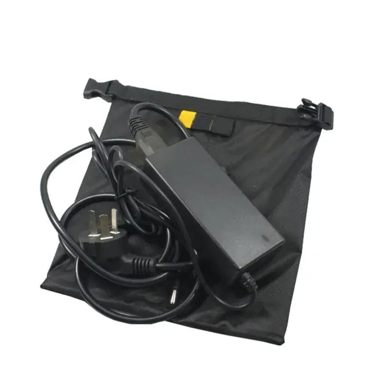 Waterproof dry bag set containing a power adapter and cables stored in a compact black pouch.