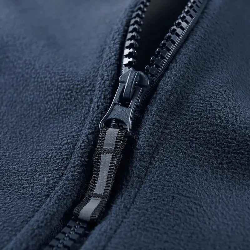 Men's navy fleece jacket close-up of sturdy zipper and warm windproof fabric