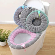 Thick plush toilet seat cushion set; 3 round rings in gray, pink, and mint green for seat and lid.