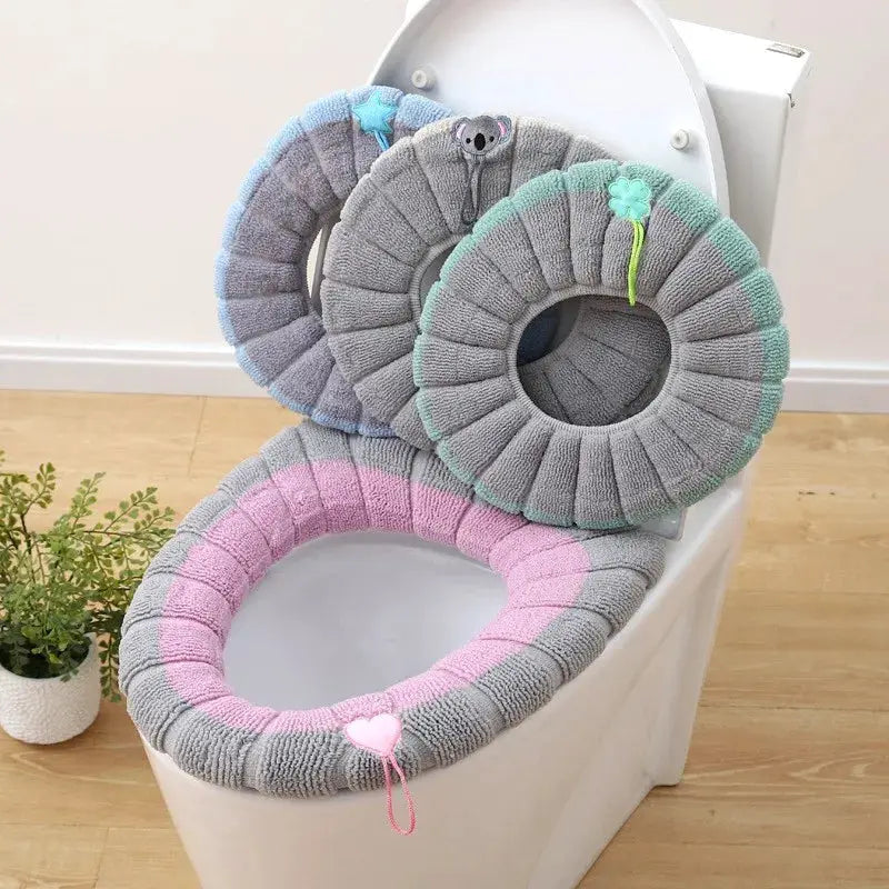 Thick plush toilet seat cushion set; 3 round rings in gray, pink, and mint green for seat and lid.