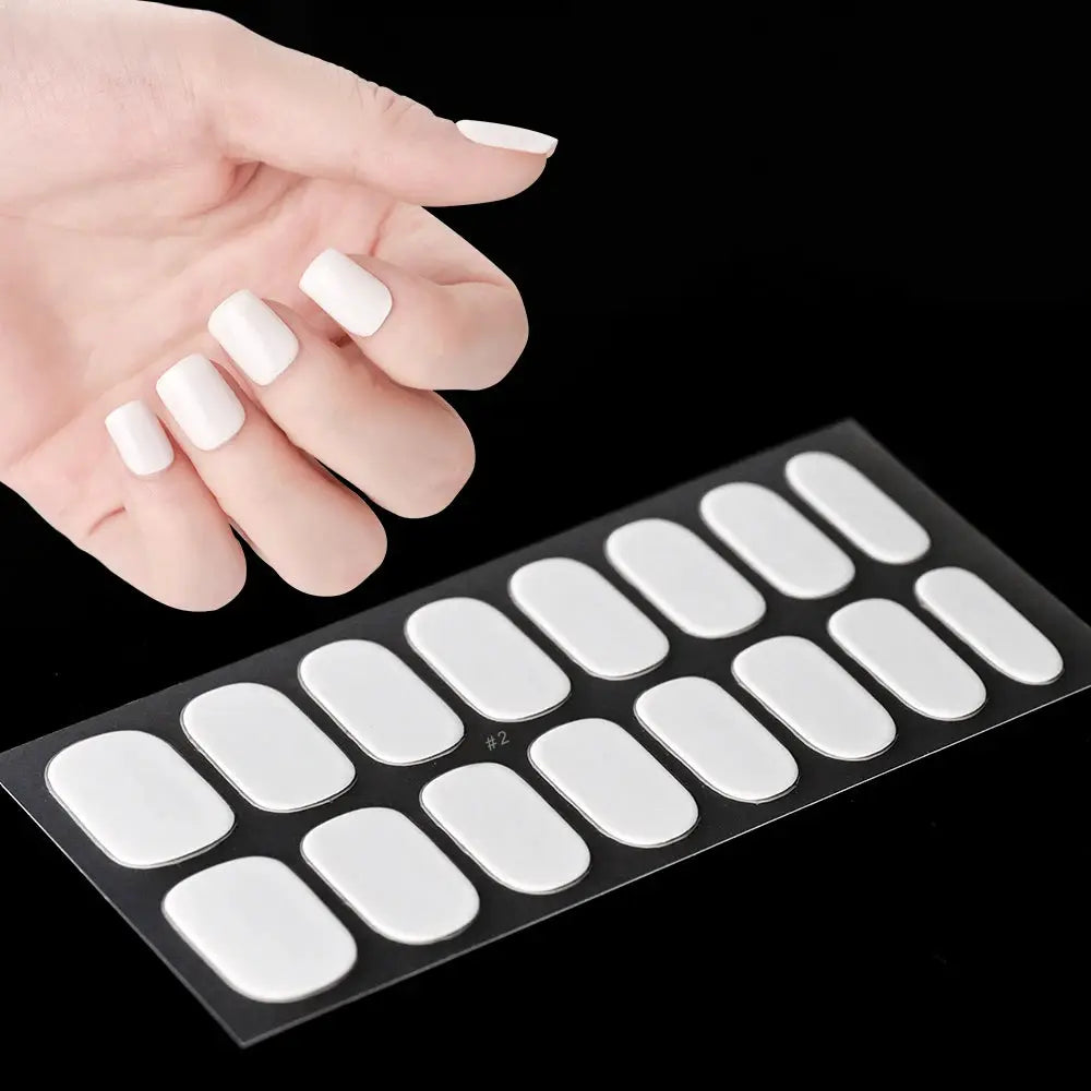 Nail wrap sheet with 16 white full-cover oval decals for manicure