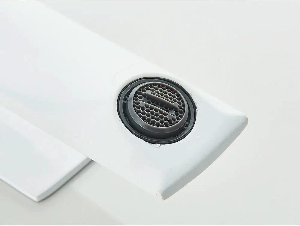 White deck-mounted bathroom faucet arm with a circular metal mesh drain cover