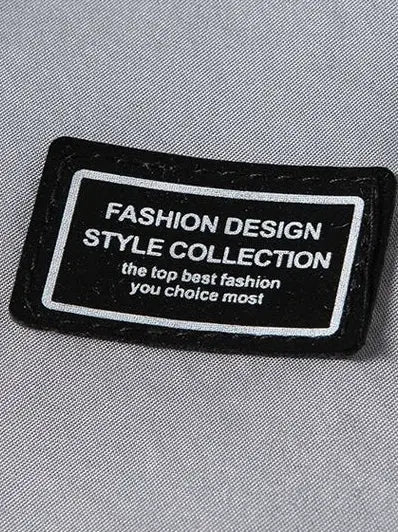 Men's windbreaker jacket with black label patch on gray fabric displaying Fashion Design Style Collection