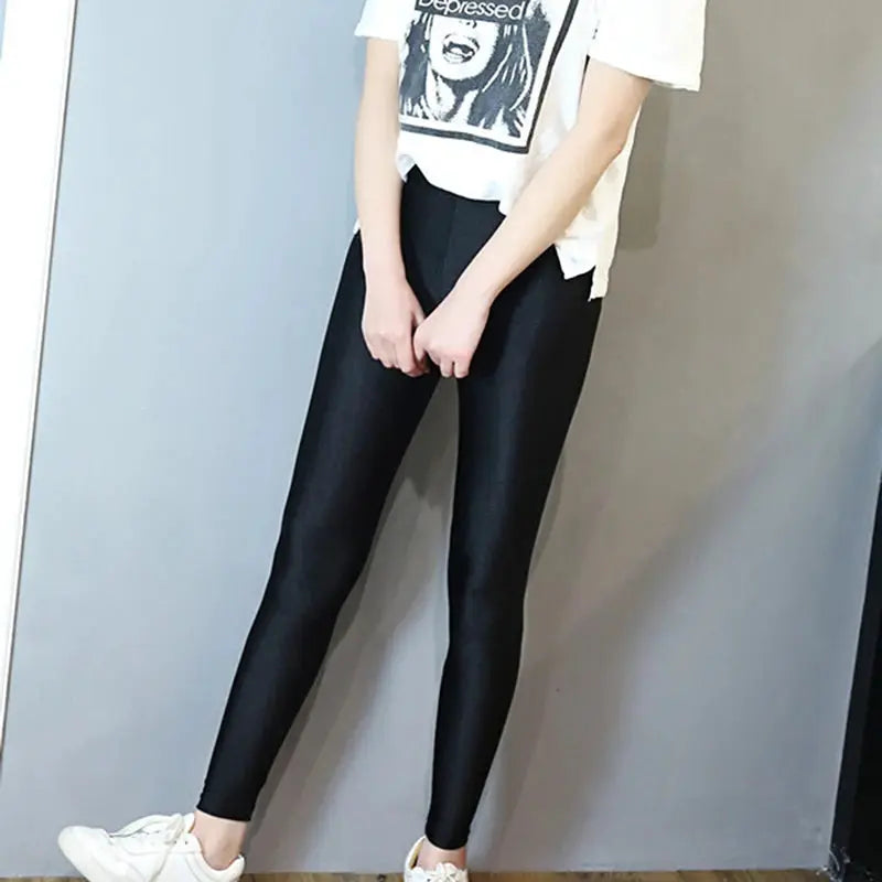 Women shiny black leggings with high waist and stretchy slim fit.