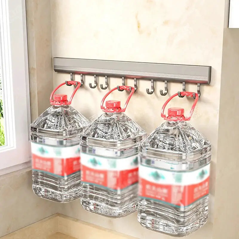 Aluminum alloy wall-mounted hook rack for kitchen storage with three large water jugs hanging