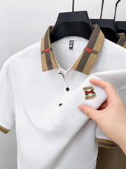 Short-sleeve polo shirt, white with beige plaid collar and cuffs, black buttons, gold B badge