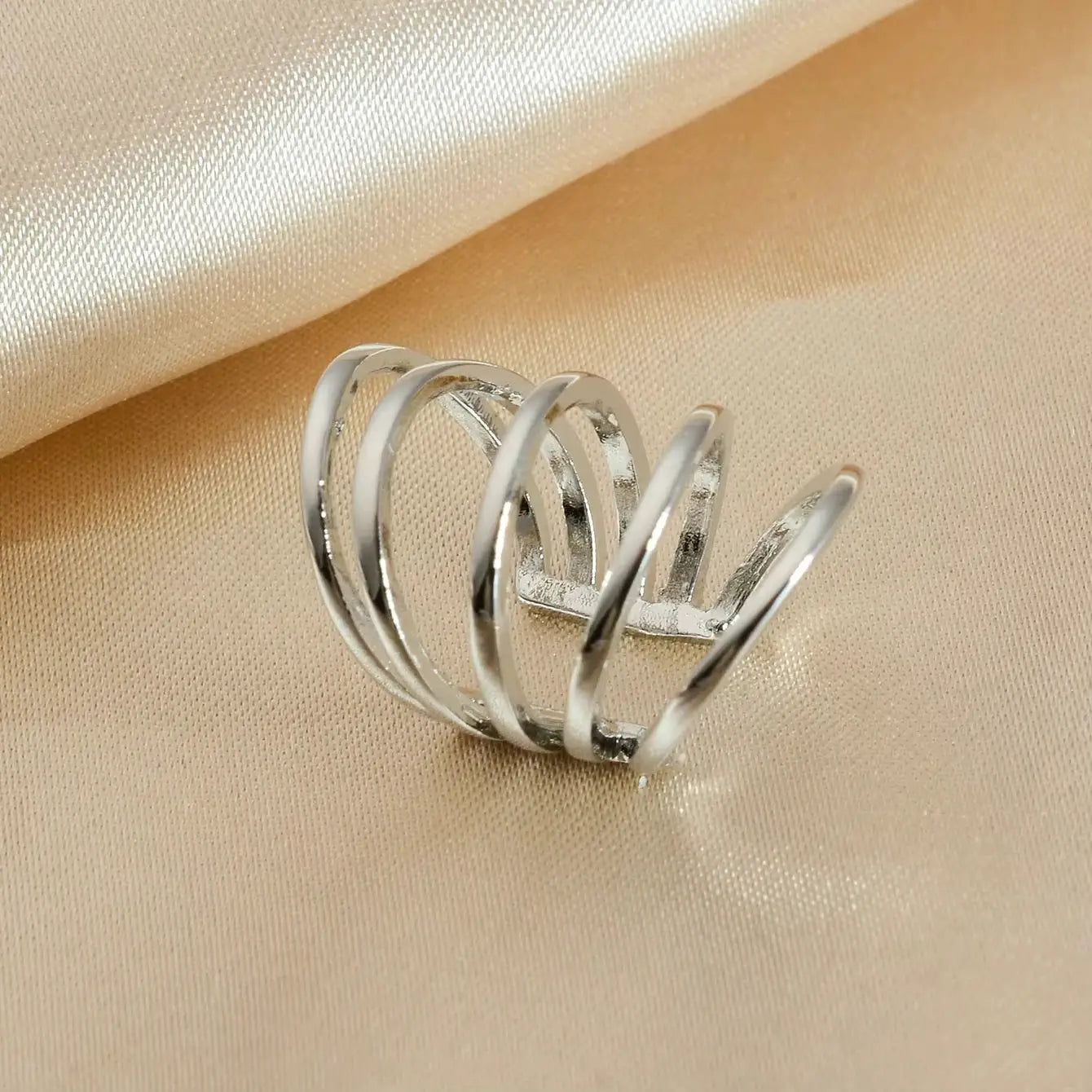 Silver clip-on ear cuff with layered spiral bands for cartilage piercings