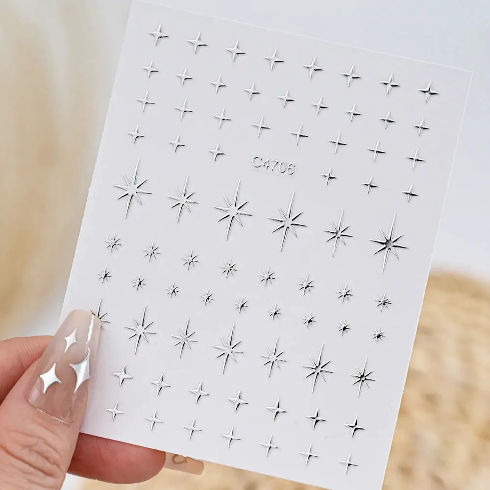 Nail stickers: metallic silver 3D star decals on a white sheet, self-adhesive
