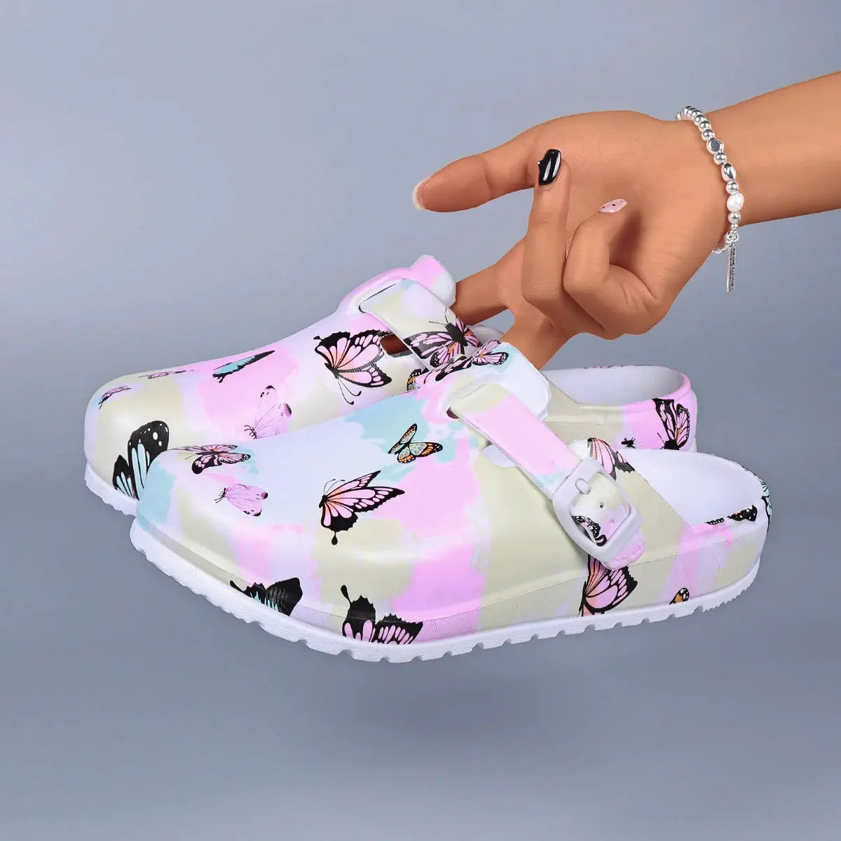 Simples Market women's butterfly-print EVA indoor clogs with white adjustable buckle strap, pastel pink and cream.