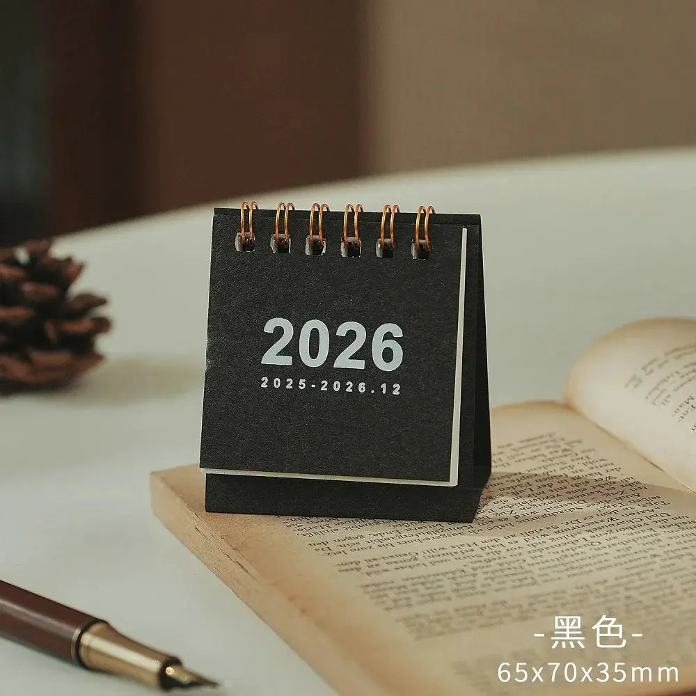 Mini black desk calendar with copper coil binding, 2026 edition
