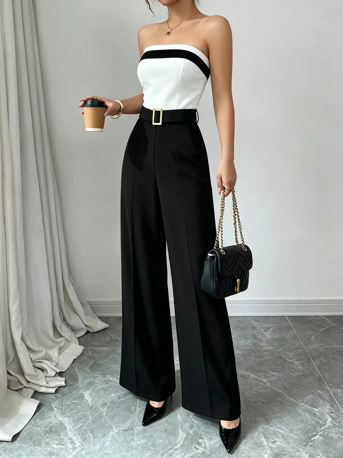 Women's black and white strapless jumpsuit with contrast trim, gold-buckle belt and wide-leg pants