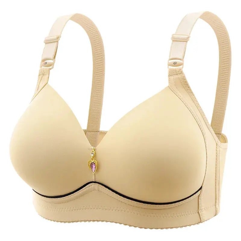 Beige glossy non-underwire molded-cup bra with adjustable straps and purple pendant between cups