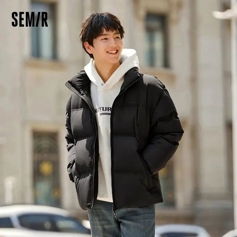 Semir down jacket; black unisex puffer coat with SEM/R logo on a city street.