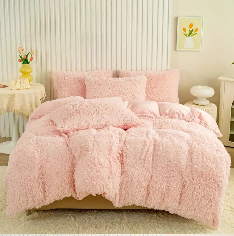 3-Piece plush pink duvet cover set on bed with fluffy pillows, cozy bedroom decor