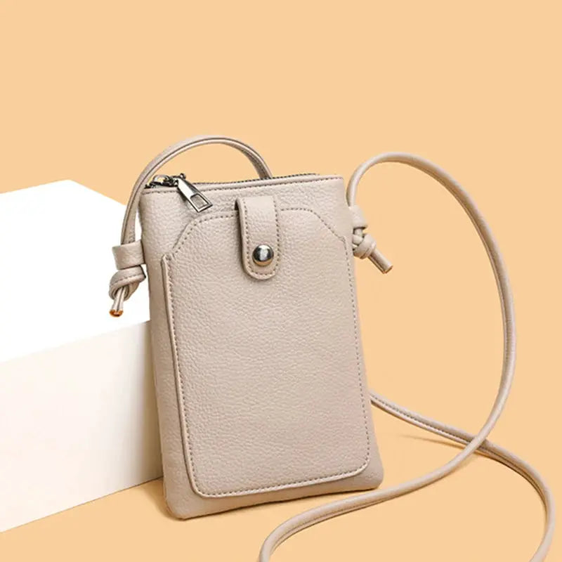 PU leather diagonal crossbody bag, beige, mini phone wallet with front buckle and long strap.