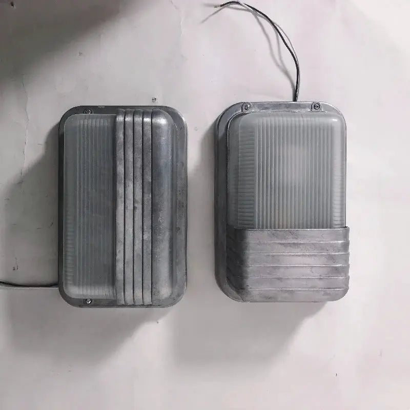 Outdoor retro LED wall light fixture pair, gray metal housing with ribbed glass panels