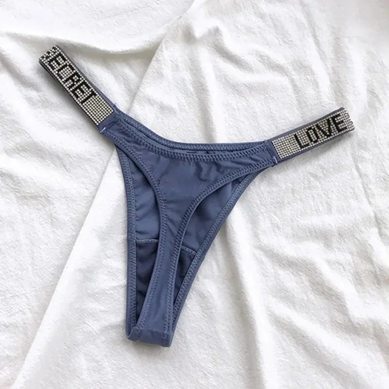 Blue-gray low-waist thong with rhinestone straps reading LOVE