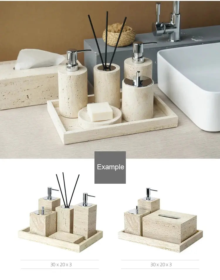 Beige travertine bathroom accessories set on a tray with two soap dispensers, reed diffuser and soap dish