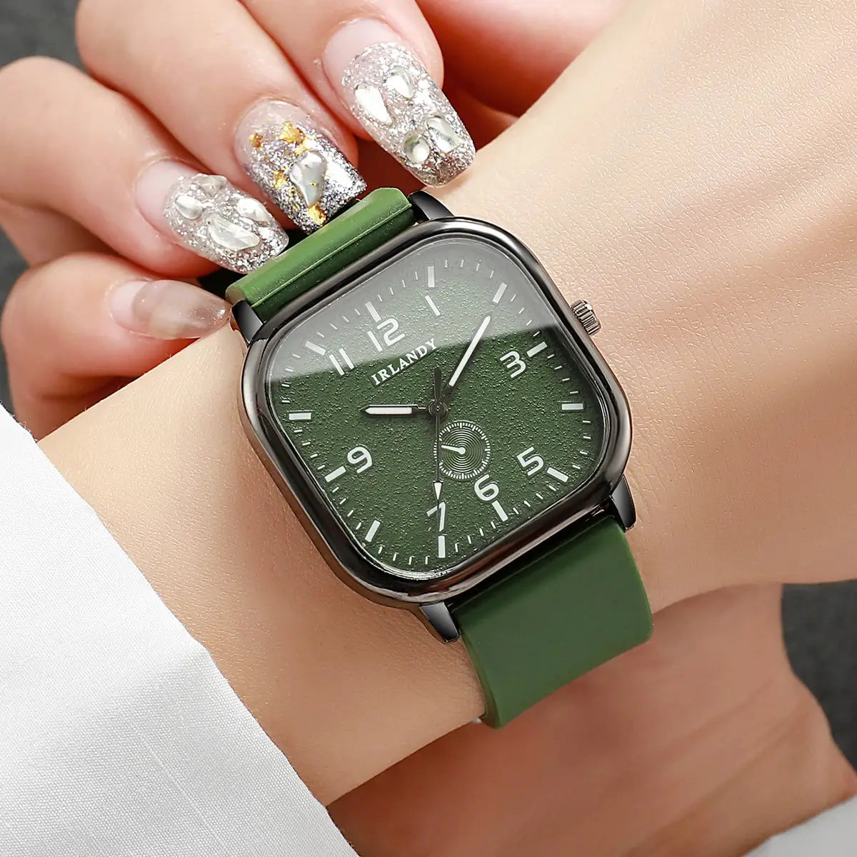 Watch with square green dial, silicone strap, and IRLANDY logo on wrist