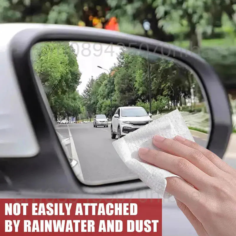 Car glass rain-repellent spray by Simples Market; hand wiping a car side mirror with a cloth