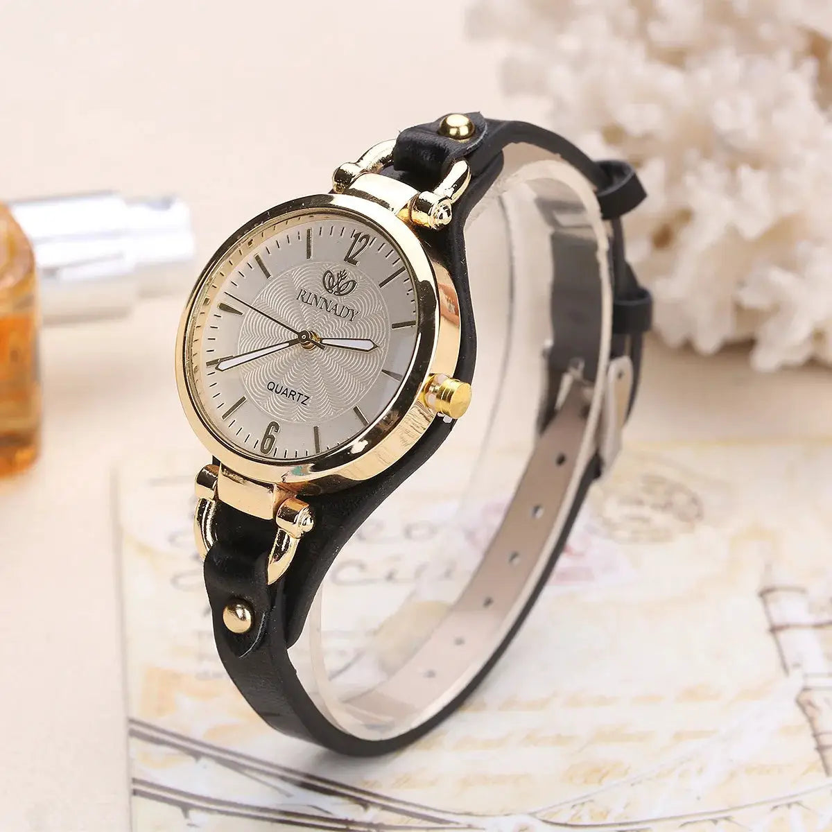 Women's quartz watch with black leather strap and gold-tone case from Simples Market