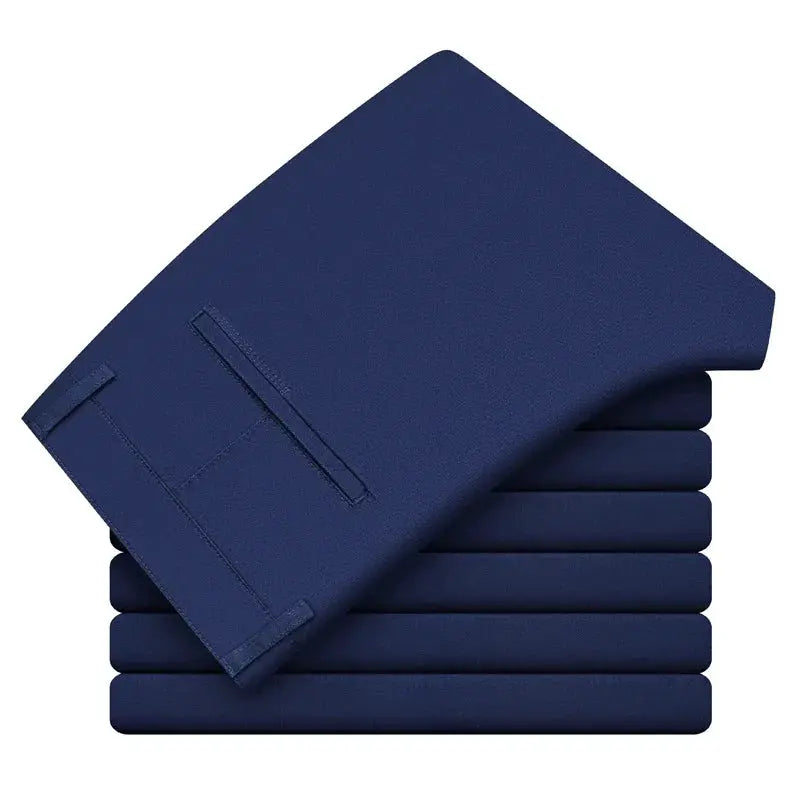 Men's navy blue casual trousers, stacked in neat folded bundles