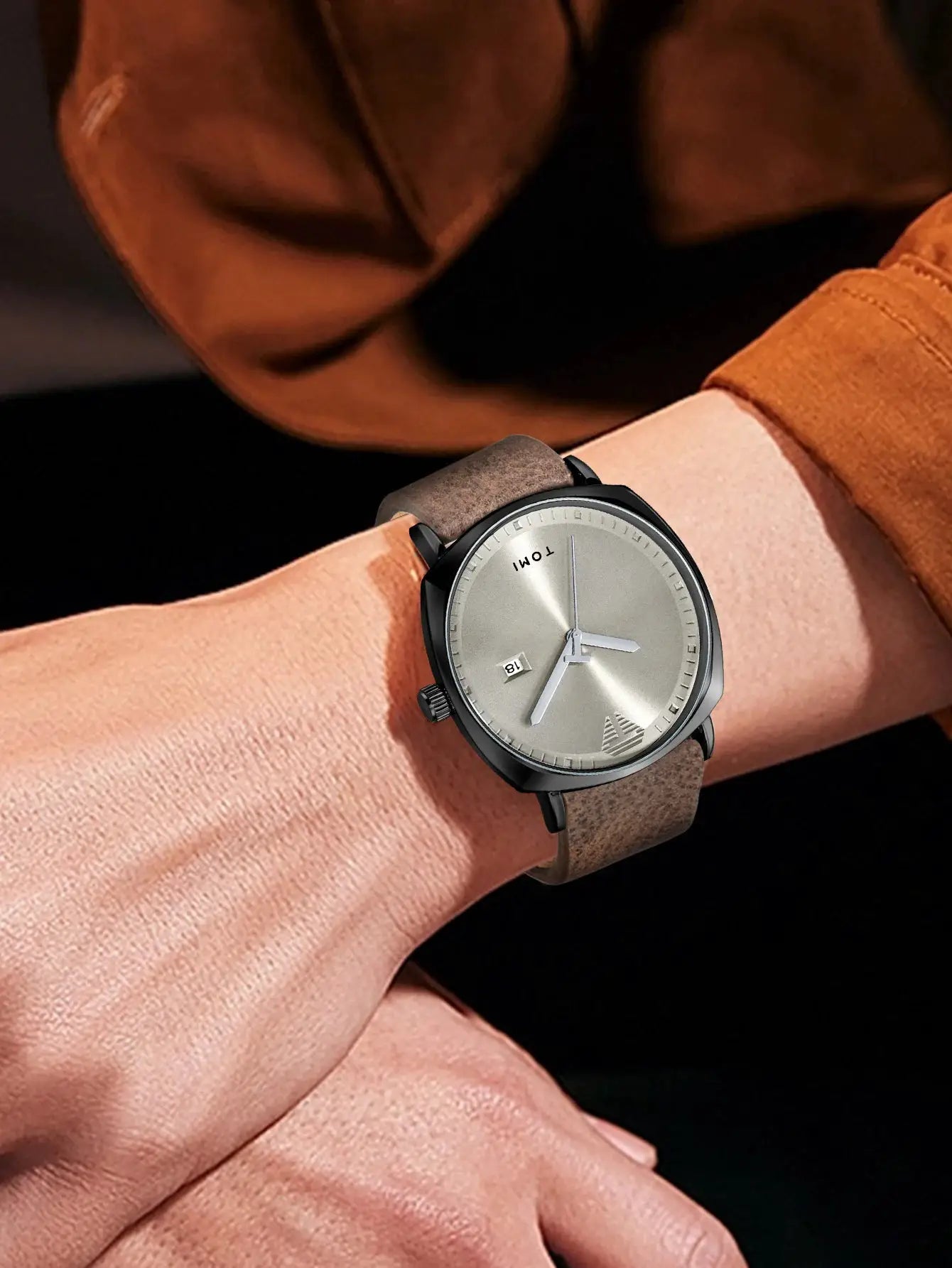 TOMI men's minimalist calendar leather quartz watch with brown strap on wrist