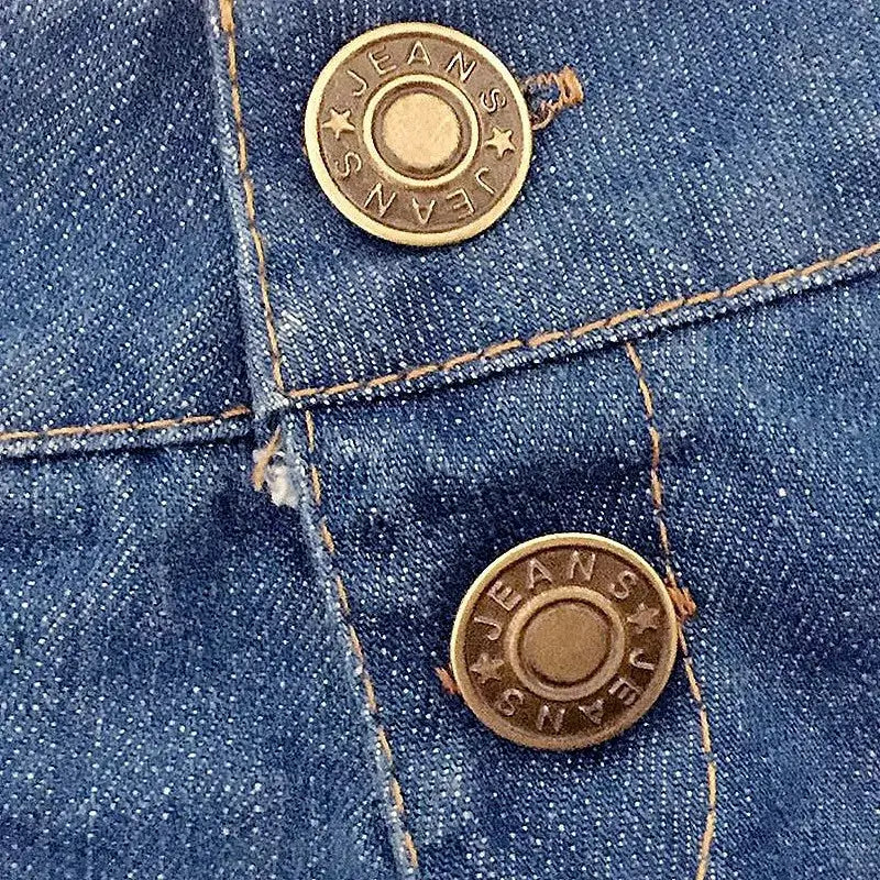Women's denim shorts close-up in blue with brass-tone buttons embossed JEANS and visible stitching