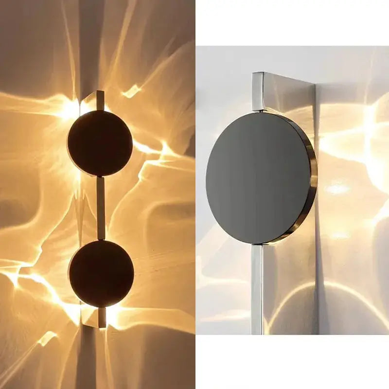 Modern LED wall light with rotatable dual circular discs on a stainless steel bar, wall sconce