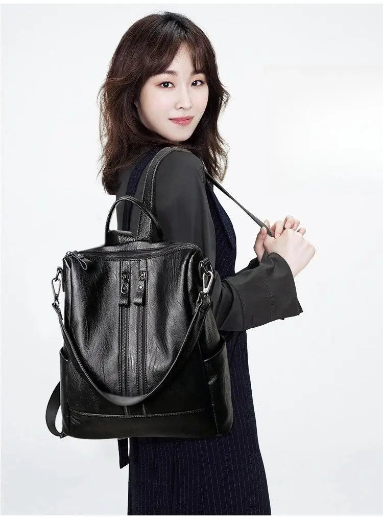 Women's black soft leather backpack with front zip pockets and adjustable straps